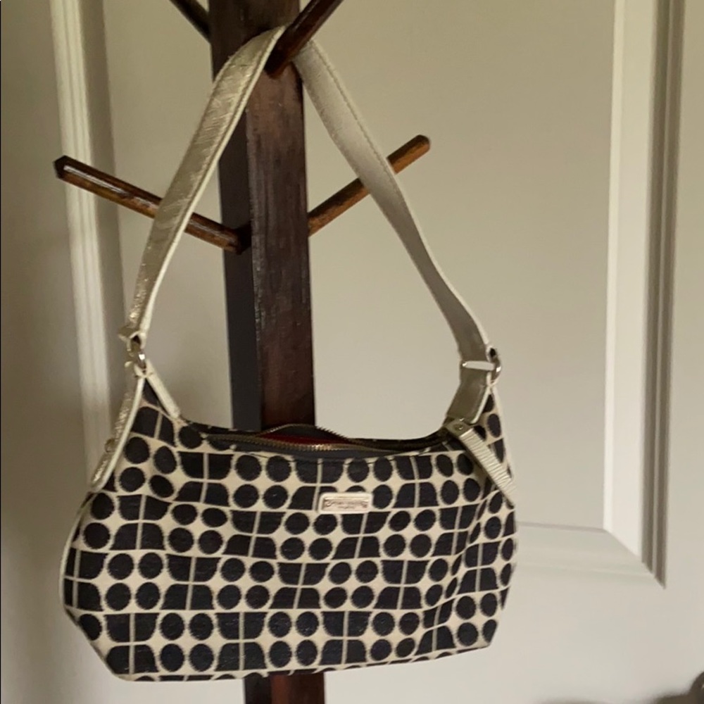 Kate Spade hand bag with off white patent short strap and black geometric design